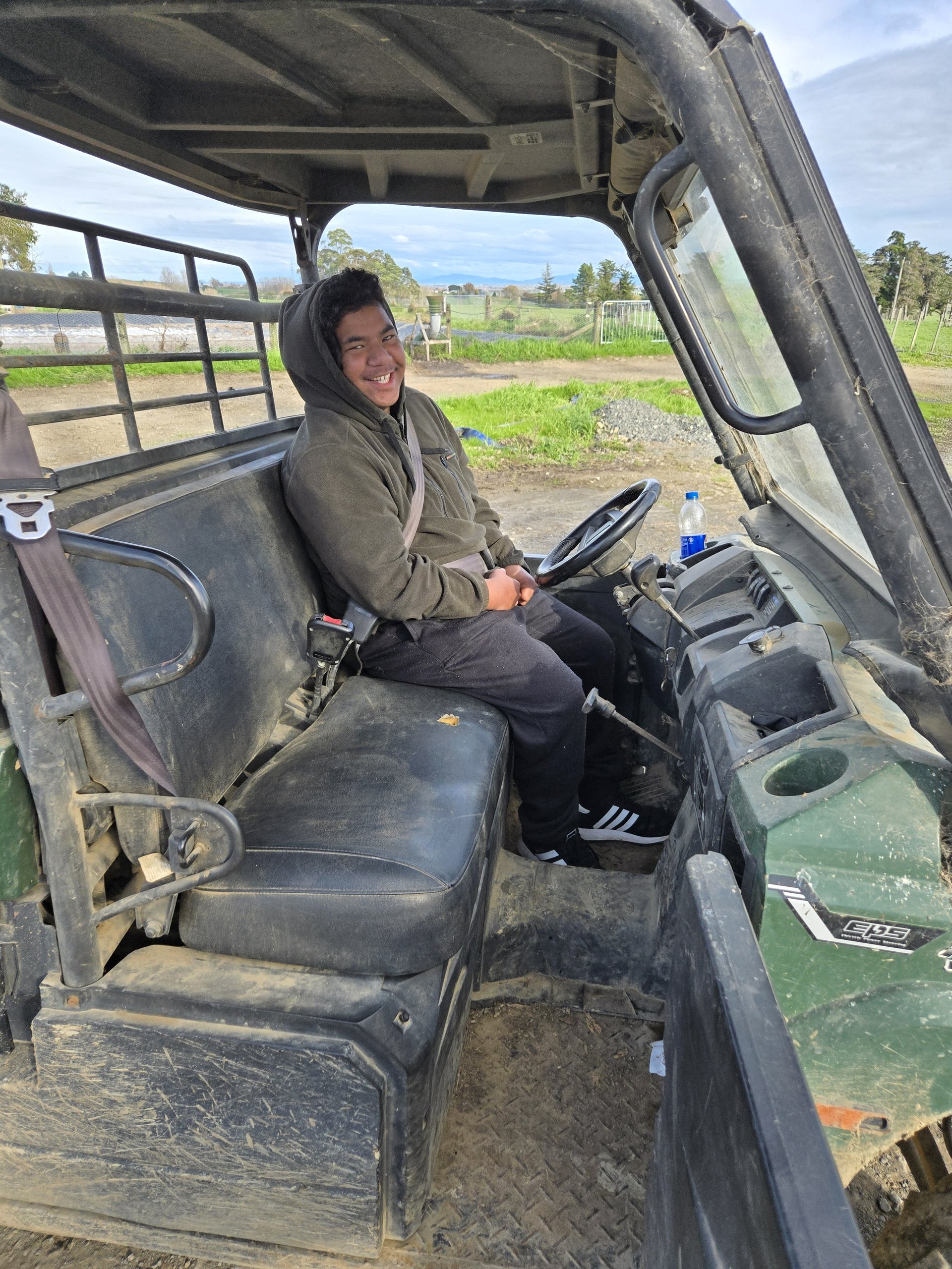 Josh sitting in a farm ATV at Rawhiti