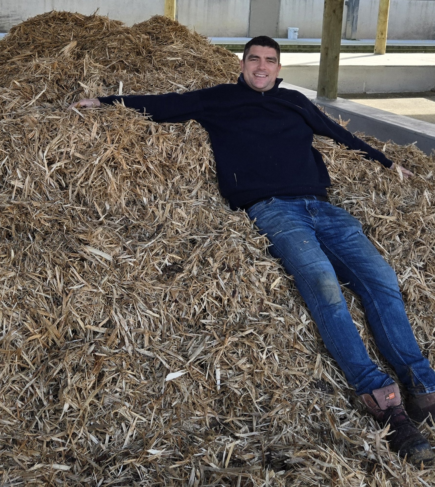 Thomas Nabbs relaxing on a pile of bedding material at Rawhiti